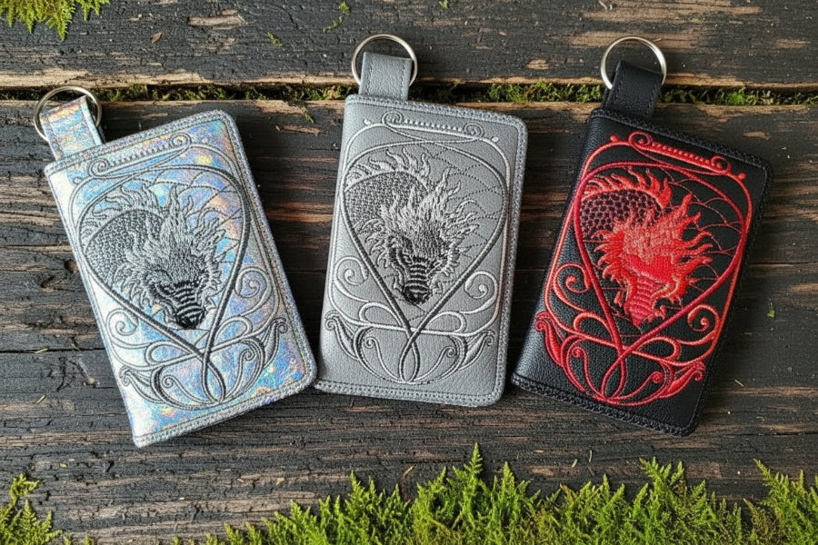 Three wallets with embroidered Chinese dragon designs in black, gray, and red colors, displayed side by side.