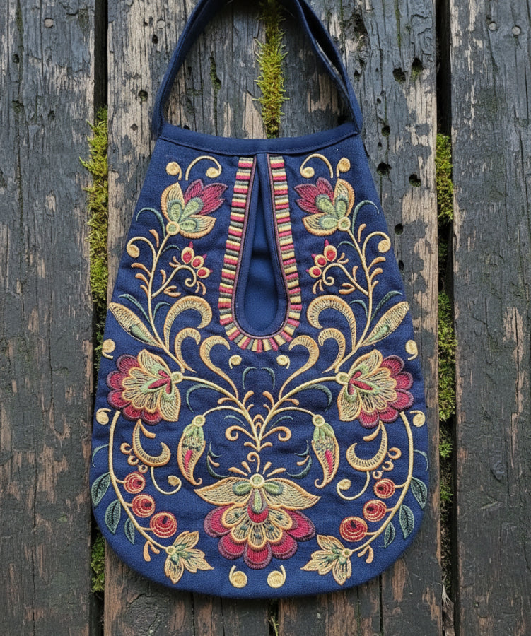 Decorative embroidered bag with floral patterns on a wooden surface