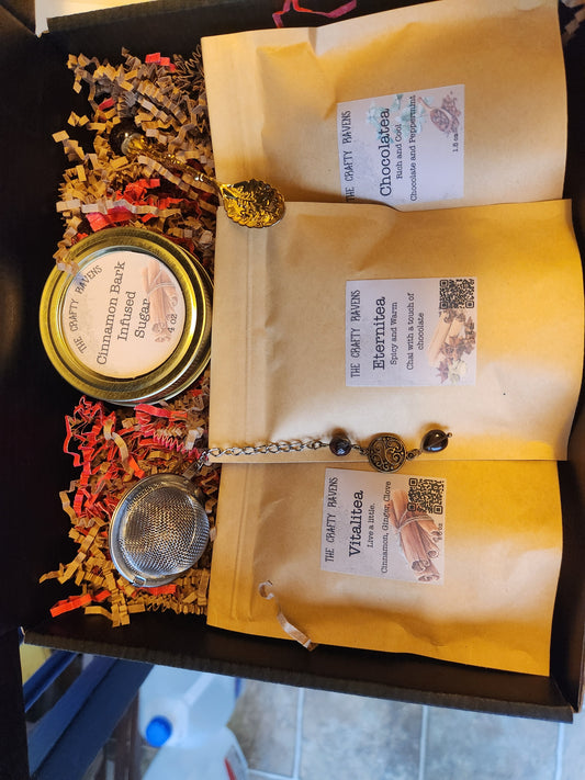 Box of 'The Crafty Raven' products including bags, a jar, and a spoon with decorative elements.