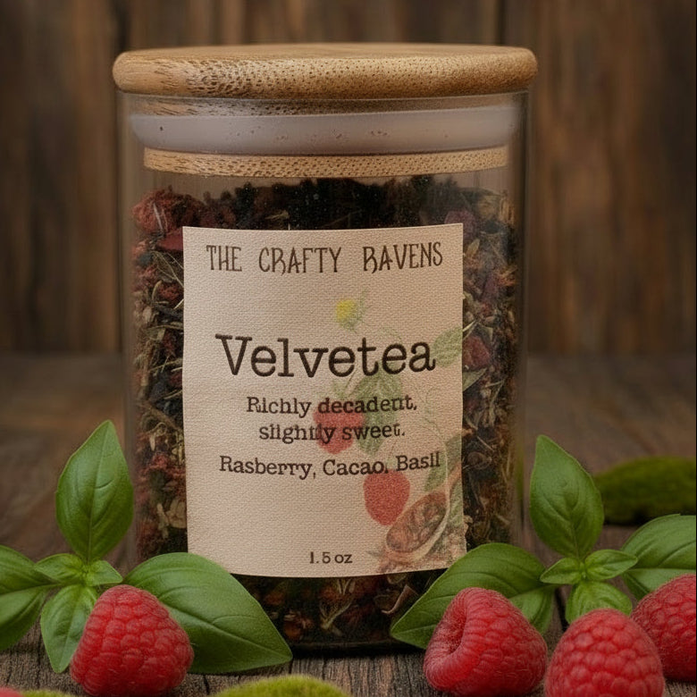 Jar of 'Velvetea' tea with raspberries and basil leaves on a wooden surface