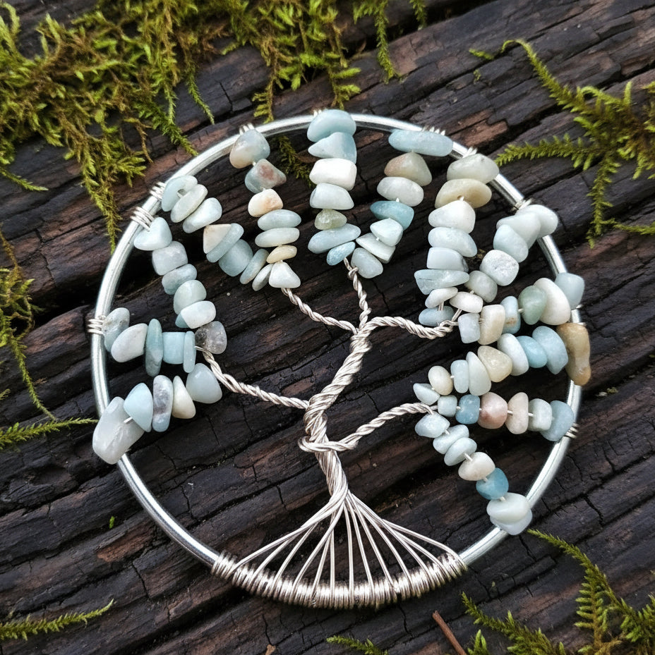 A circular suncatcher with a silver ring and tarnish resistant silver wire, featuring blue calcite crystals shaped like a tree with a branch design.