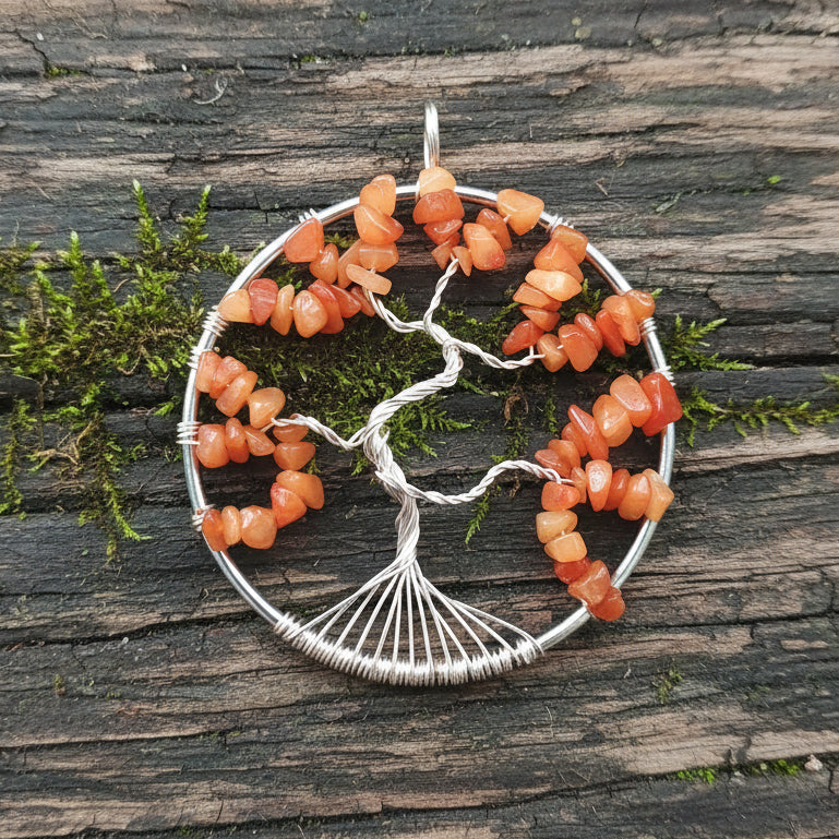A silver-colored suncatcher featuring a tree-like structure made from red aventurine crystals, with tarnish-resistant silver wire used for the branches.