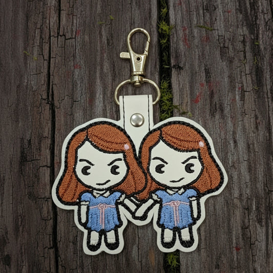 Keychain with cartoon characters on a wooden background