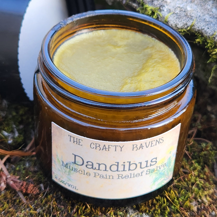 Open jar of Dandibus Muscle Pain Relief Cream on a textured surface